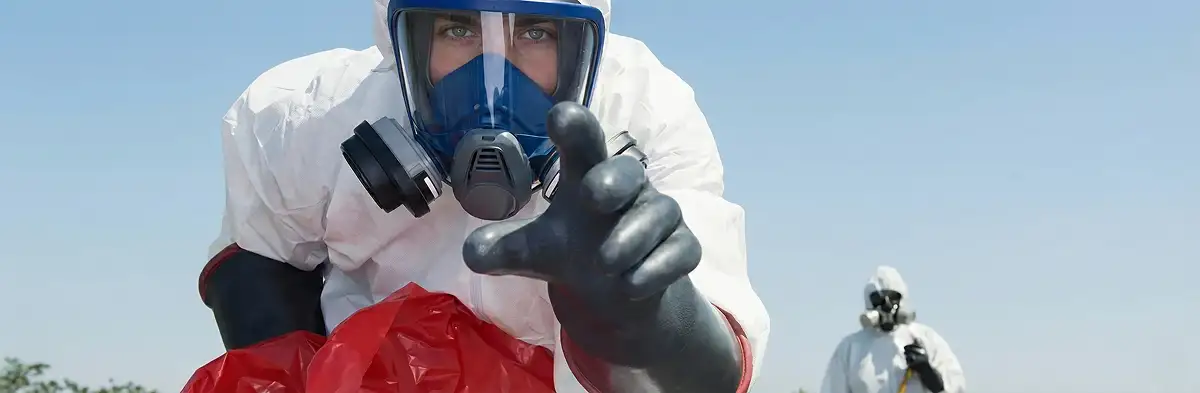 sewage clean up technician wearing protective gear handling biohazard materials in Los Angeles, CA